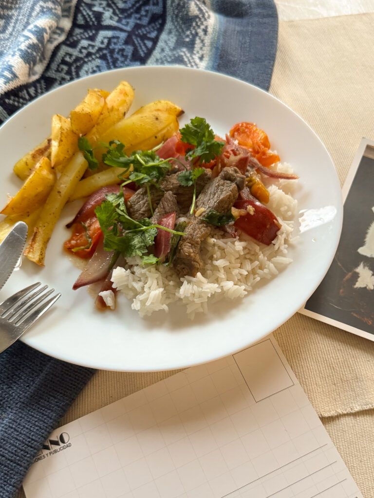 Lomo saltado podane na białym talerzu.