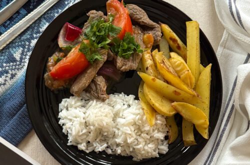 Lomo Saltado w woku: Przepis krok po kroku na Lomo Saltado. Klasyczne danie peruwiańskiej kuchni Chifa. Smażona wołowina, papryka i pomidory, podawane z ryżem i frytkami. Jak zrobić Lomo Saltado w domu?