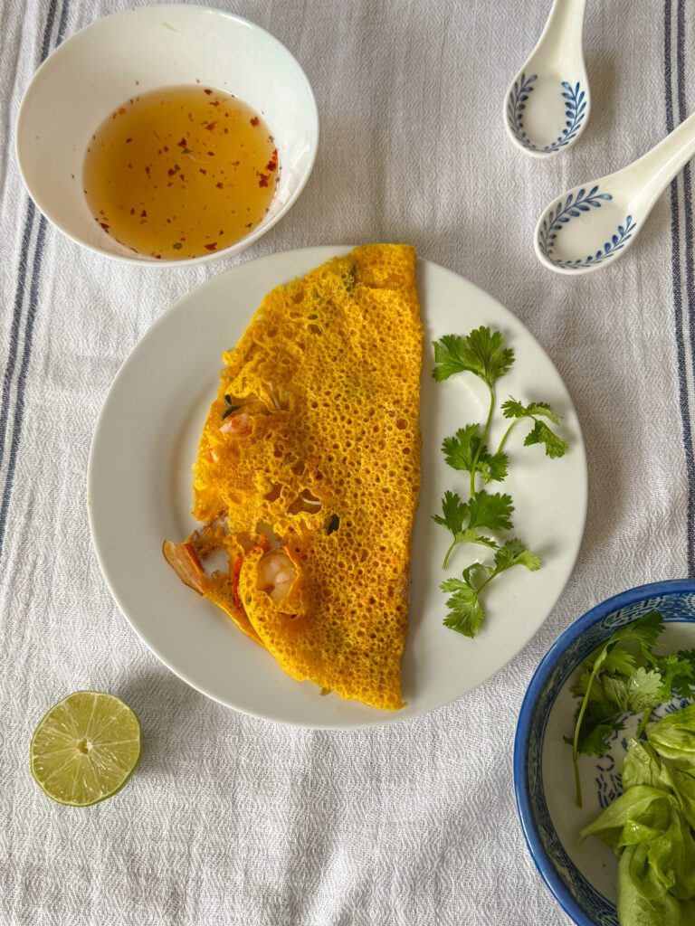  Banh xeo - wietnamskie naleśniki z krewetkami Chrupiący naleśnik, soczysta krewetka i aromatyczny boczek – wszystko to znajdziesz w Banh Xeo. Ten wietnamski przysmak przeniesie Cię prosto do serca Azji Południowo-Wschodniej. Obiad w 20 minut? Tak, to możliwe – ten przepis jest prosty, egzotyczny i pyszny.